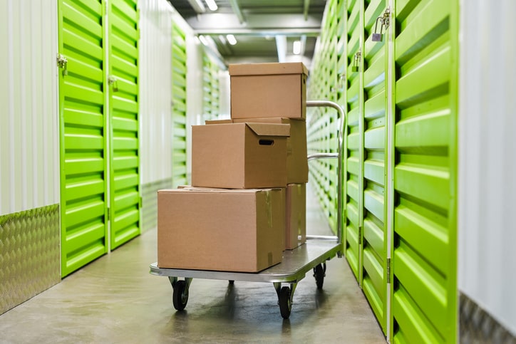 Boxes sitting on a cart in the hallway of a storage facility, in the process of transferring business files to self storage